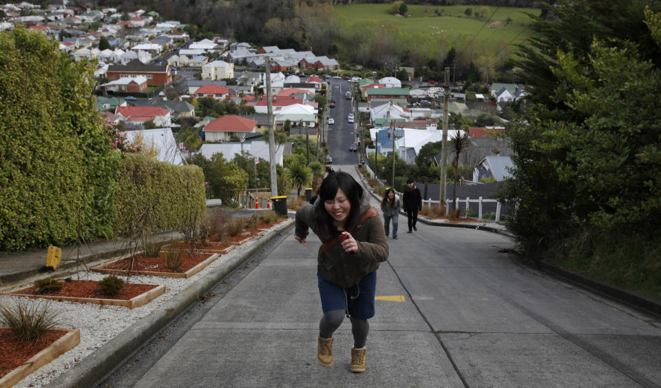 Yui Okuda from Japan, runs up Baldwin street in Dunedin, New Zealand, Monday, Sept. 12, 2011. Baldwin Street is considered one of the world's steepest residential streets. (AP Photo/Natacha Pisarenko)