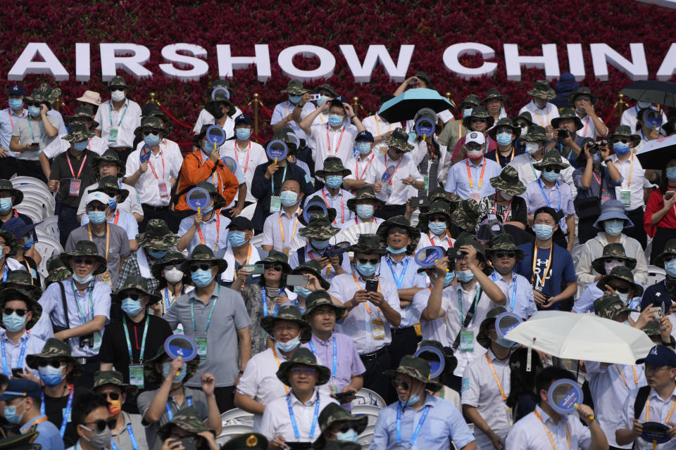 Visitors watch an airshow during the 13th China International Aviation and Aerospace Exhibition, also known as Airshow China 2021, on Tuesday, Sept. 28, 2021, in Zhuhai in southern China's Guangdong province. (AP Photo/Ng Han Guan)