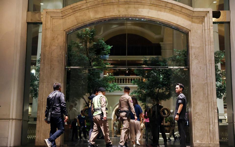 Police enter the Grand Hyatt Erawan hotel