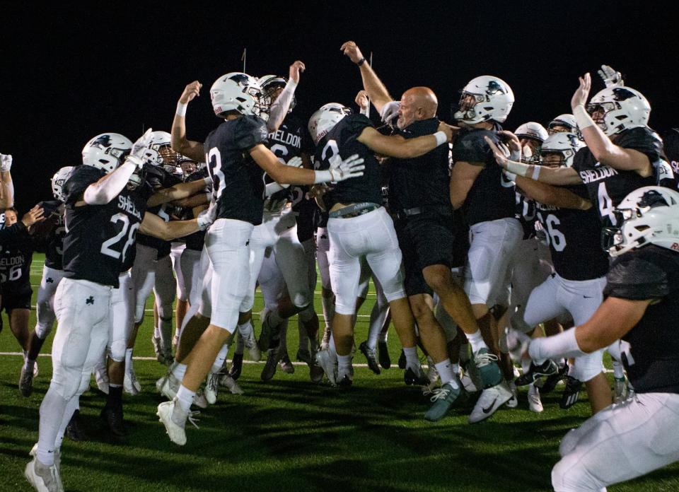 Sheldon players celebrate with coach Josh Line after their win. The Sheldon Irish defeated the South Medford Panthers 49-0 Friday, Oct. 7, 2022, at Sheldon High School in Eugene, Ore. 