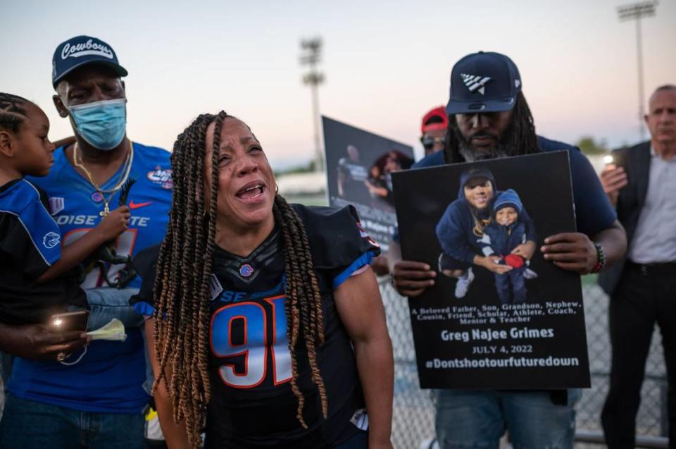 Deborah Grimes, center, mourns her son, 31-year-old Greg Najee Grimes, while her husband, Gregory Grimes, holds their 4-year-old grandson, Jaceyon, during a vigil on July 5, after Greg was killed outside a downtown Sacramento nightclub on July 4, a few months after the April mass shooting. The vigil was held at Inderkum High School, where Greg was a football star before playing at Boise State and later returned as an assistant coach and worked with children in special education.
