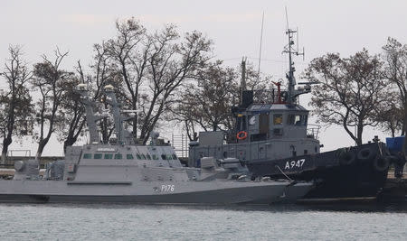 Seized Ukrainian ships, small armoured artillery ships and a tug boat, are seen anchored in a port of Kerch, Crimea November 26, 2018. REUTERS/Pavel Rebrov