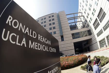 People walk past the entrance to the Ronald Reagan UCLA Medical Center in Los Angeles, California February 19, 2015. REUTERS/Jonathan Alcorn