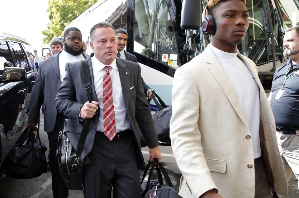 Former Tennessee head football coach Butch Jones, center, arrives before an NCAA college football game between Alabama and Tennessee Saturday, Oct. 20, 2018, in Knoxville, Tenn. (AP Photo/Wade Payne)