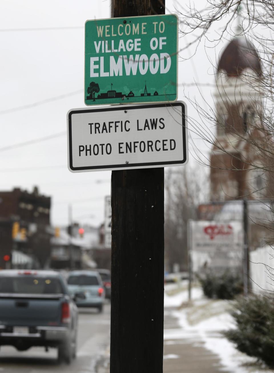 FILE - This photo made Thursday, Jan. 16, 2014, shows a sign advising motorists they may be monitored by traffic cameras in Elmwood Place, Ohio, after the cameras were removed by a ruling from Hamilton County Common Pleas Judge Robert Ruehlman. Judge Ruehlman ruled Thursday, Jan. 23 the village must refund nearly $1.8 million to drivers who received speeding camera tickets there, pending an appeal. (AP Photo/Al Behrman, file)