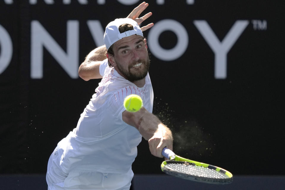 Maxime Cressy of the U.S. plays a backhand return to during their third round match at the Australian Open tennis championships in Melbourne, Australia, Saturday, Jan. 22, 2022. (AP Photo/Simon Baker)