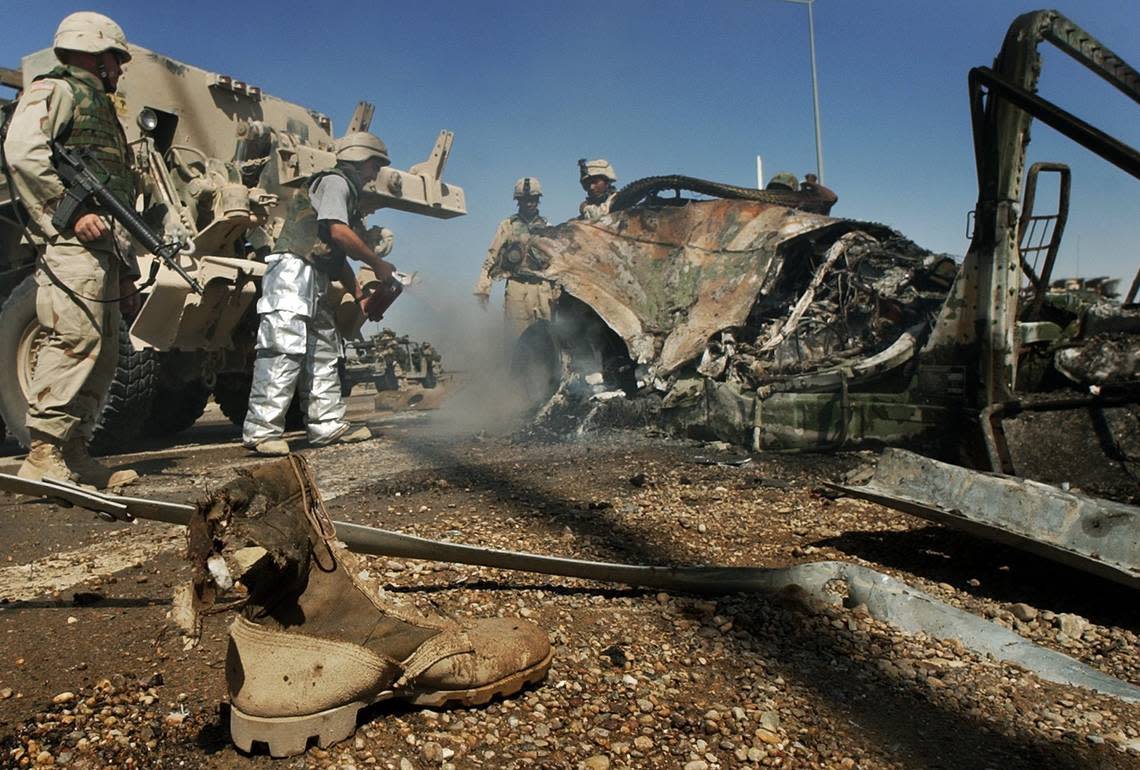 The boot of Spec. George Perez sits near the smoldering wreckage of an 82nd Airborne Division vehicle on Hwy 1 in Al Fallujah Sunday Sept.14,2003. The 1/504 humvee hit an Improvised Explosive Device (IED) while on morning patrol. One soldier was killed and three others injured.