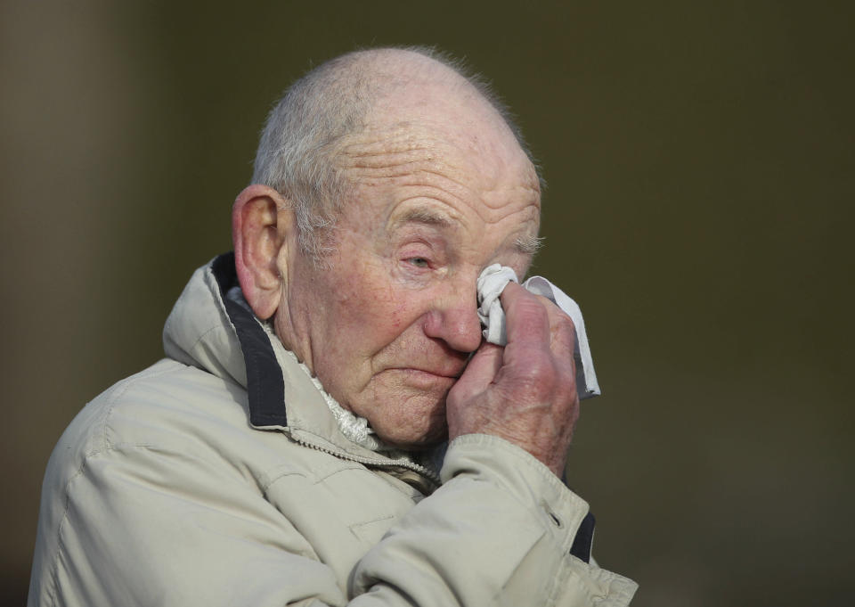 Tony Foulds, 82, reacts after warplanes from Britain and the United States staged a joint flypast tribute to ten US airmen Friday Feb. 22, 2019, at Endcliffe Park in Sheffield, 75-years after Foulds witnessed the crash that killed them. Foulds was just a child playing in the park on Feb. 22, 1944, when a U.S. Air Force crew decided to crash and die rather than take the chance of hitting the playing children. For decades Foulds has tended a memorial dedicated to honouring the 10 U.S. airmen who died in the plane crash at Endcliffe Park, and today the flypast fulfils his wish for the men who saved his life. (Danny Lawson/PA via AP)