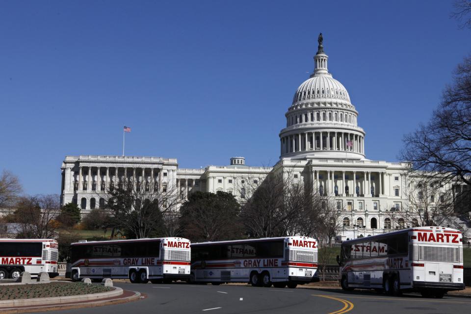 FILE - In this March 23, 2009 file photo, tour buses line up in front of the U.S. Capitol in Washington. Whether visitors want to try one of the first family’s favorite restaurants, discover a sense of history or escape from the crowd to find a museum off the beaten path, Washington is the nation’s cultural capital this weekend for inauguration visitors. (AP Photo/Jacquelyn Martin, File)