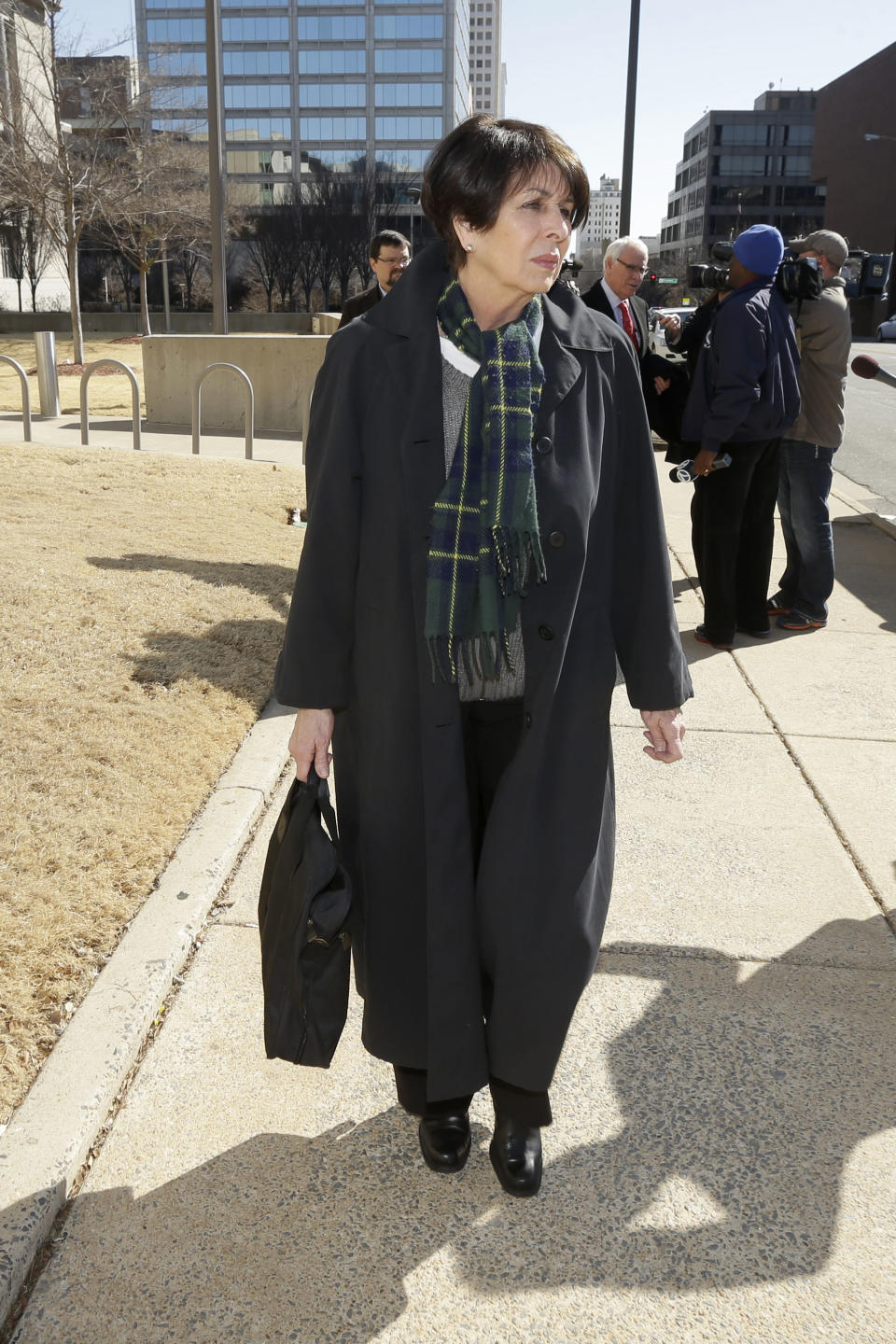 Former Arkansas treasurer Martha Shoffner walks from the federal courthouse in Little Rock, Ark., after she pleaded not guilty to mail fraud charges that allege she misspent thousands of dollars in campaign money on personal items.Thursday, Feb. 27, 2014. (AP Photo/Danny Johnston)