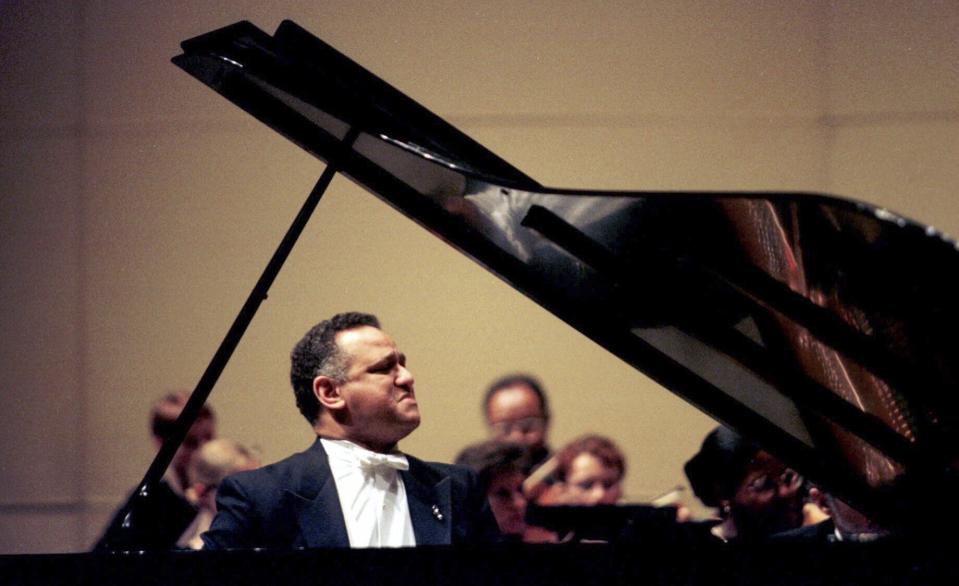 FILE - Pianist Andre Watts performs with the Kalamazoo (Mich.) Symphony Orchestra during the opening concert of the Irving S. Gilmore International Keyboard Festival at Miller Auditorium on the Kalamazoo (Mich.) campus of Western Michigan University, on April 29, 2000. Watts died Wednesday, July 12, 2023 in Bloomington, Ind. He was 77.(Henrik Edsenius/Kalamazoo Gazette via AP)