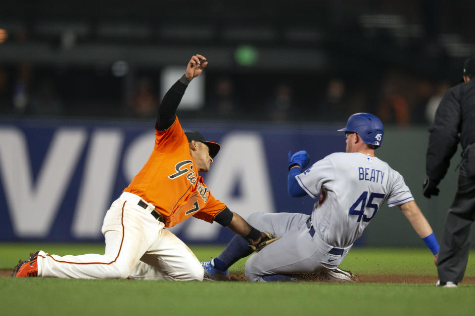 San Francisco Giants second baseman Donovan Solano (7) puts the tag on Los Angeles Dodgers' Matt Beaty (45) on an attempted steal of second base during the ninth inning of a baseball game Friday, May 21, 2021, in San Francisco. (AP Photo/D. Ross Cameron)