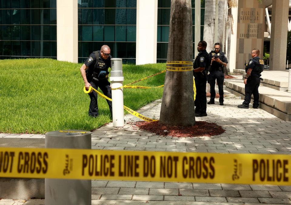 Department of Homeland Security police place tape off an area in front of the Wilkie D Ferguson Jr federal courthouse in Miami on 12 June (Getty Images)