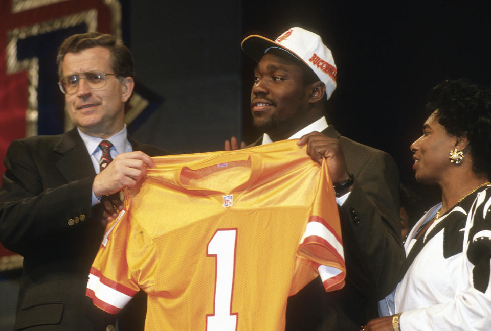 Warren Sapp, standing with late NFL commissioner Paul Tagliabue, wasn't thrilled when the Bucs made him the 12th overall pick in the 1995 NFL draft. (Photo by Focus on Sport/Getty Images)