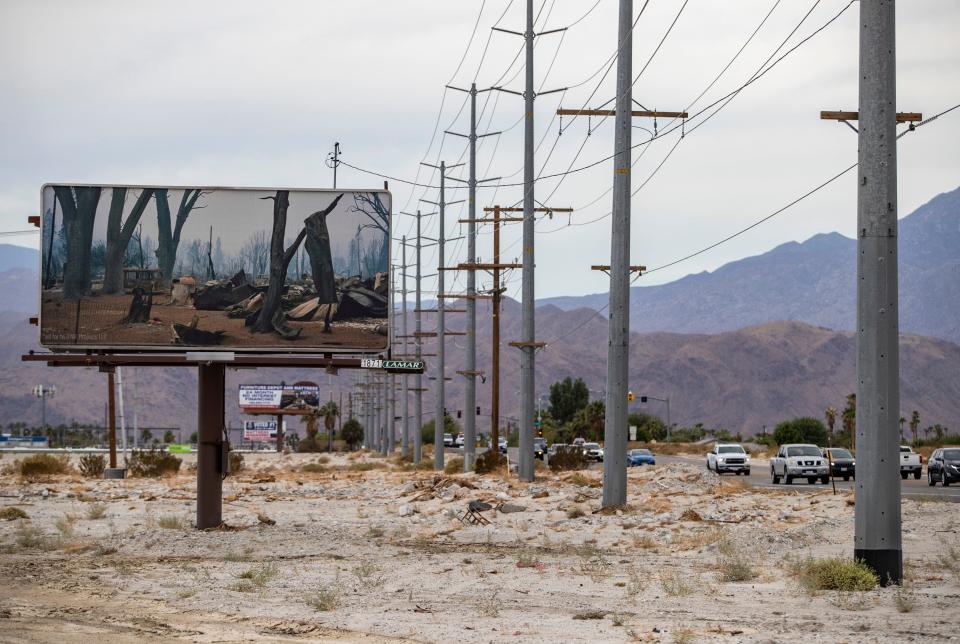 A billboard featuring a photograph by Thomas Broening showing wildfire aftermath is seen along Gene Autry Trail in Palm Springs, Calif., Saturday, Aug. 13, 2022. 