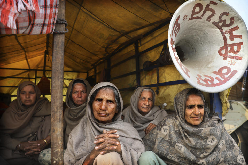 Elderly women farmers sit at the back of a trailer as they participate in a protest against new farm laws at the Delhi-Haryana state border, on the outskirts of New Delhi, India, Sunday, Dec. 27, 2020. From students, teachers and nurses to housewives and grandmothers, women are now holding the front lines at the massive protests that have blockaded key highways leading to India's capital for more than a month, demanding the repeal of new farm laws. (AP Photo/Manish Swarup)