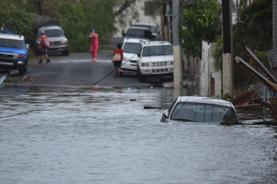 A car is viewed stuck in a flooded street in Santurce, in San Juan.&nbsp;