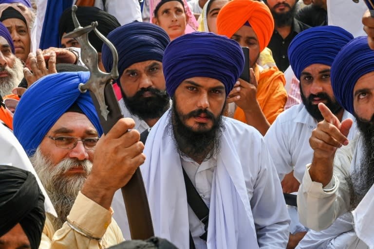 Amritpal Singh (C) temporarily left jail to be sworn into India's parliament after he won resounding victory in last month's election from behind bars (Narinder NANU)