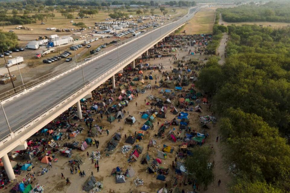 An aerial view of migrants, many from Haiti, on Sept. 21, 2021, at an encampment along the Del Rio International Bridge near the Rio Grande in Del Rio, Texas. (AP Photo/Julio Cortez)