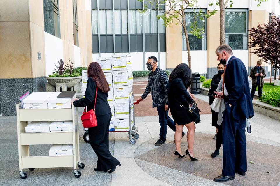 Members of Apple's legal team roll exhibit boxes into the Ronald V. Dellums building in Oakland, Calif., as the company faces off in federal court against Epic Games on Monday, May 3, 2021.