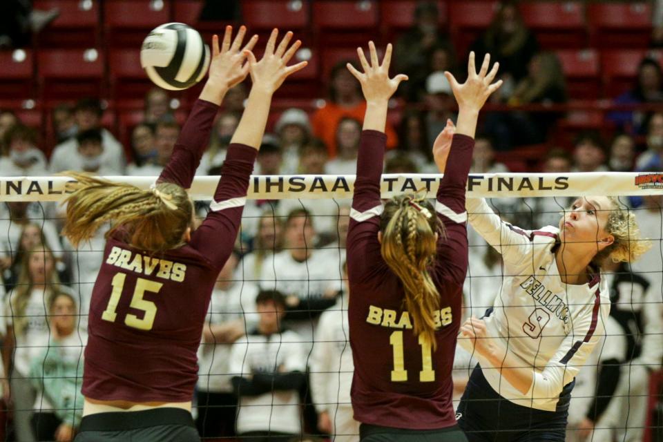 Bellmont's Delaney Lawson (9) spikes the ball against Brebeuf's Maeve Perry (15) and Brebeuf's Delaney Seaman (11) during the second set of the IHSAA Class 3A volleyball state finals, Saturday, Nov. 6, 2021 at Ball State University's Worthen Arena in Muncie.