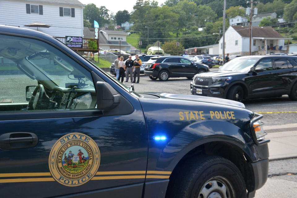 FILE - A heavy police presence is on scene of a Nutter Fort, W.Va., funeral home, Aug. 24, 2022, after an officer-involved shooting of a fugitive suspect occurred in the funeral home's parking lot. Charges will not be brought against members of a West Virginia task force who fatally shot a pallbearer at his father’s funeral after an investigation found the fugitive was reaching for a concealed weapon, a special prosecutor said Tuesday, April 18, 2023. (Jonathan Weaver/The Exponent via AP, File)