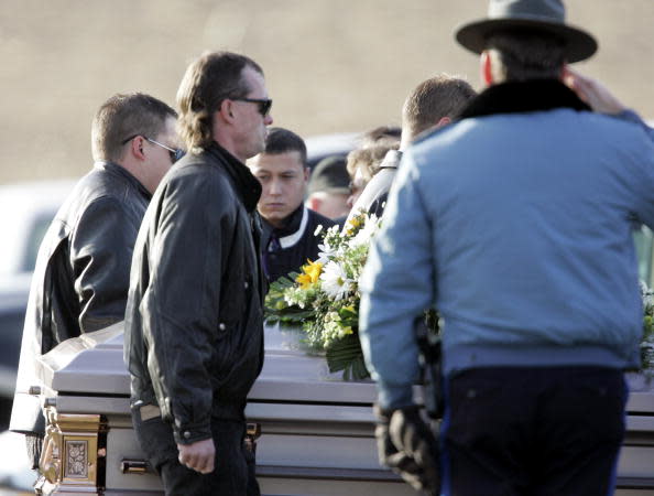 Zeb Stinnett stands in Hillcrest Cemetery while the casket of his late wife, Bobbi Jo Stinnett, is carried past him in Skidmore, Missouri. 