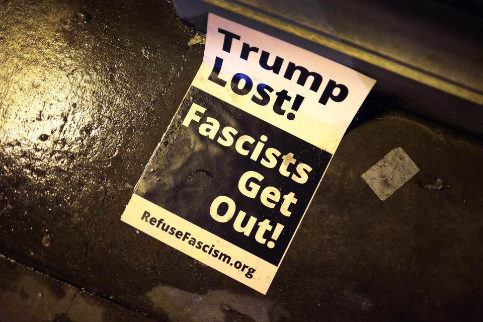 CHICAGO, ILLINOIS - JANUARY 07: A protest sign rests on the ground near a small group of demonstrators protesting near Trump Tower on January 07, 2021 in Chicago, Illinois. Protesters called for the removal of President Donald Trump from office after a pro-Trump mob stormed the Capitol building in Washington, DC yesterday as lawmakers met to count the Electoral College votes in the presidential election.  (Photo by Scott Olson/Getty Images)