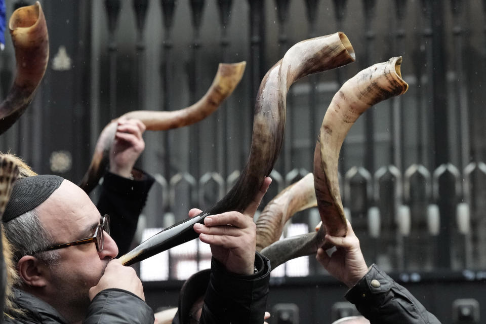 Jewish people and sympathisers blow shofars (ram's horns of spiritual significance) and whistles in London, Sunday, March 10, 2024 to show solidarity with the 100 plus hostages held in Gaza. The 'blow' lasted for 1.55 minutes marking the 155 days they have spent in captivity. (AP Photo/Frank Augstein)