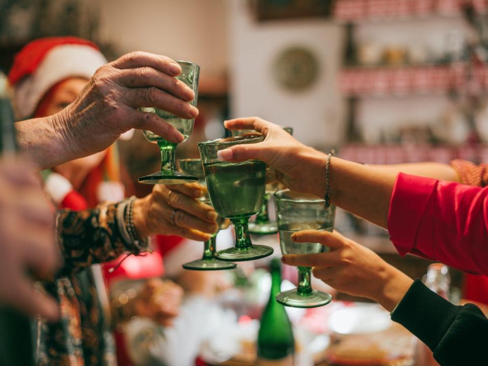 A family toasts during Christmas dinner