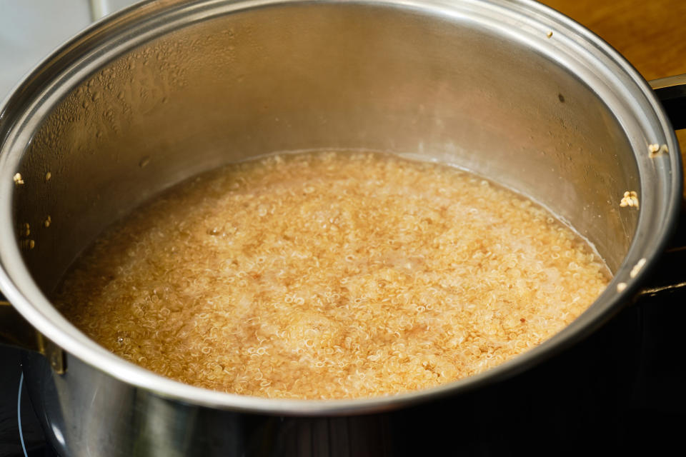 Preparing quinoa in a cooking pot on stove