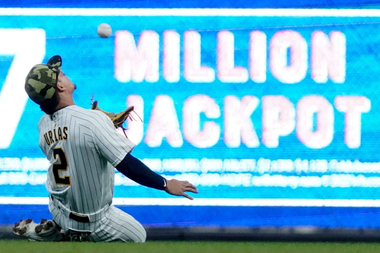 Milwaukee Brewers' Luis Urias makes a running catch on a ball hit by Washington Nationals' Nelson Cruz during the first inning of a baseball game Saturday, May 21, 2022, in Milwaukee.