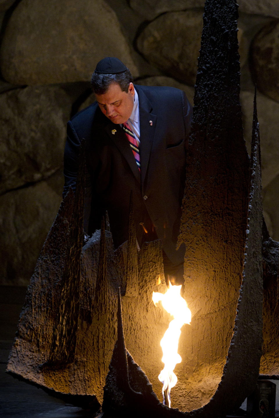 New Jersey Gov. Chris Christie rekindles the Eternal flame at the Hall of Remembrance at the Yad Vashem Holocaust memorial, in Jerusalem, Tuesday, April 3, 2012.Christie kicked off his first official overseas trip Monday meeting Israel's leader in a visit that may boost the rising Republican star's foreign policy credentials ahead of November's presidential election. (AP Photo/Bernat Armangue)