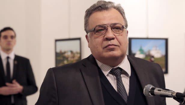 The man behind Andrei Karlov is Mevlut Mert Altintas, a rogue police officer who pulled out a gun seconds after this photo was taken. Photo: AP