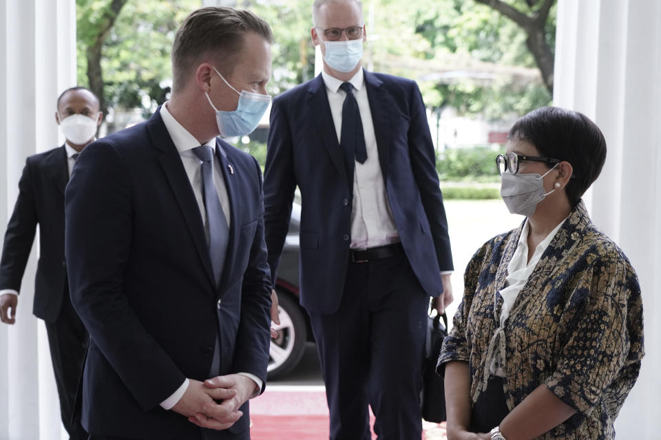In this photo released by Indonesian Ministry of Foreign Affairs, Denmark's Foreign Minister Jeppe Kofod, left, talk with his Indonesian counterpart Retno Marsudi during their meeting in Jakarta, Indonesia, Monday, Nov. 22, 2021. (Indonesian Ministry of Foreign Affairs via AP)
