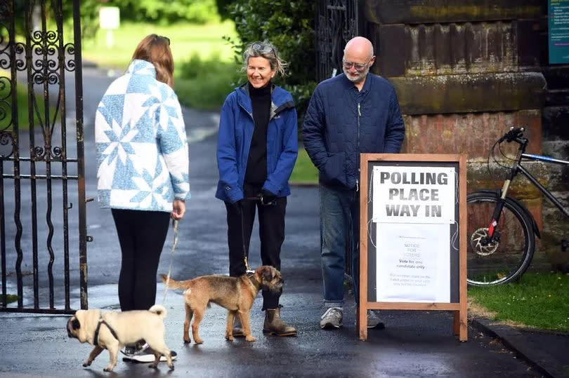 GLASGOW, SCOTLAND - JULY 4: People arrive to cast their votes during the general election at Pollokshields Burgh Hall on July 4, 2024 in Glasgow, United Kingdom. Voters in 650 constituencies across the UK are electing members of Parliament to the House of Commons via the first-past-the-post system.  Rishi Sunak announced the election on May 22, 2024. The last general election that took place in July was in 1945, following the Second World War, which resulted in a landslide victory for Clement Attlee's Labour Party. (Photo by Michael Boyd/Getty Images)