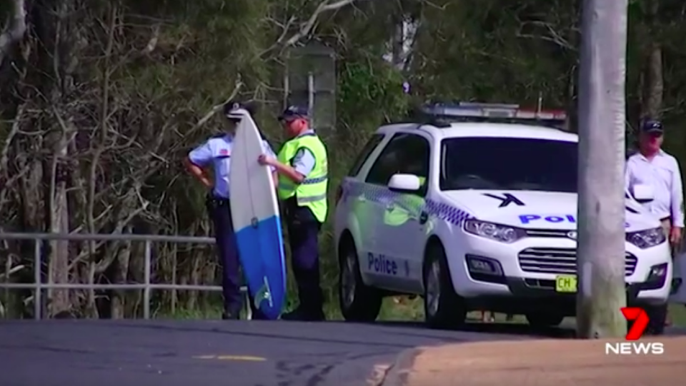 Officers hold Mr Mason’s board following the attack. Source: 7News