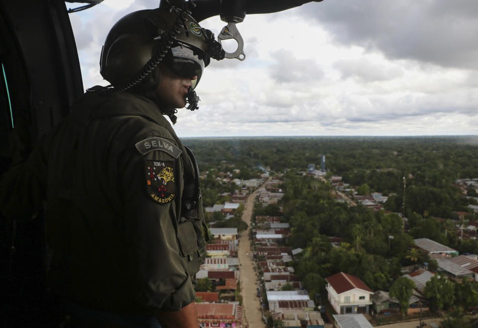 Soldiers search for missing British journalist Dom Phillips and Indigenous affairs expert Bruno Araujo Pereira from a helicopter over Javari Valley Indigenous territory, Atalaia do Norte, Amazonas state, Brazil, Friday, June 10, 2022. Phillips and Pereira were last seen on Sunday morning in the Javari Valley, Brazil's second-largest Indigenous territory which sits in an isolated area bordering Peru and Colombia. (AP Photo/Edmar Barros)