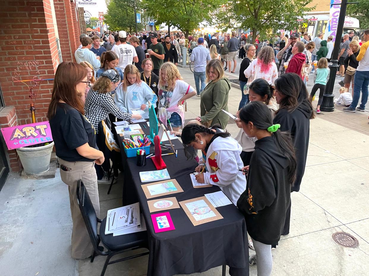 Art x Love guides attendees of the Cuyahoga Falls Oktoberfest in an art project.