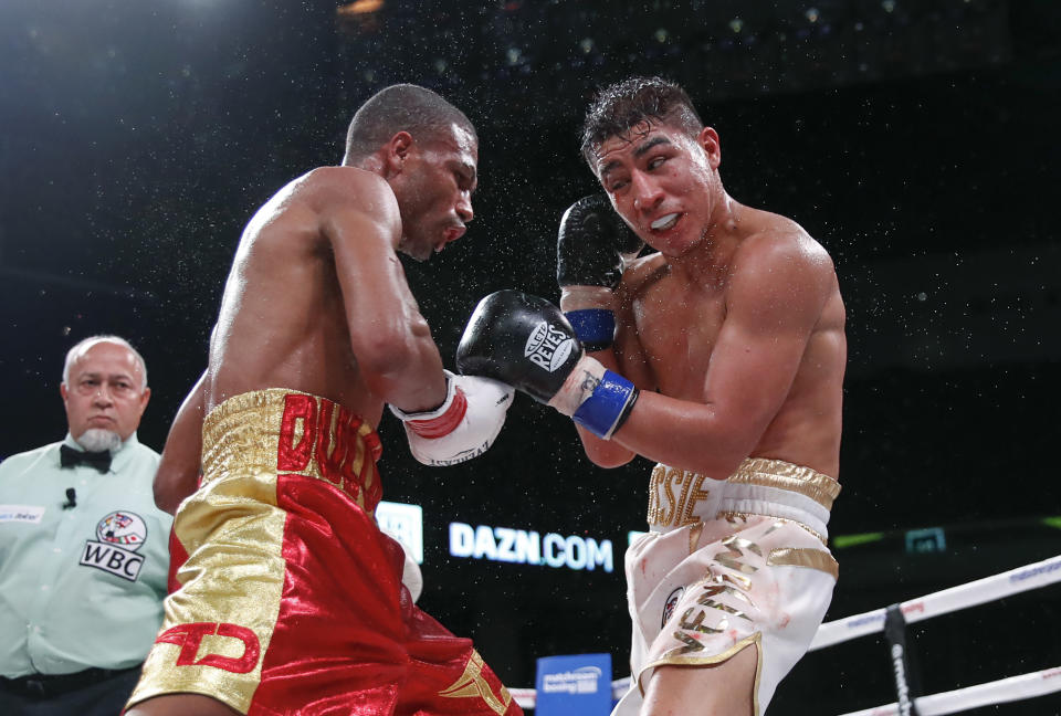 Sweat flies during a boxing bout between Thomas Dulorme, left, Jessie Vargas on Saturday, Oct. 6, 2018, in Chicago. (AP Photo/Kamil Krzaczynski)