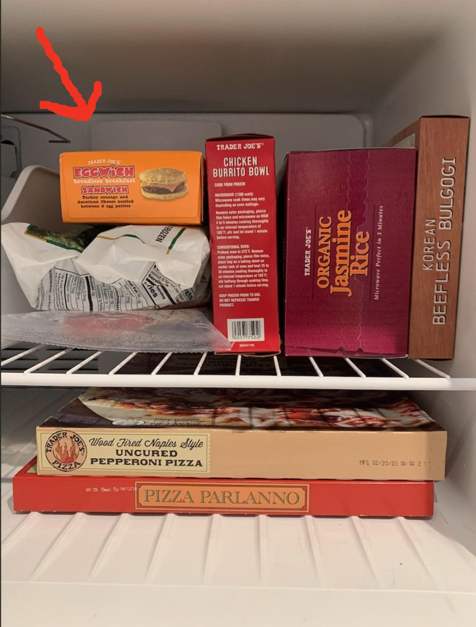 A freezer full of Trader Joe's, with an arrow pointing to the Eggwich sandwiches