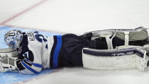 Winnipeg Jets goaltender Connor Hellebuyck remains on the ice after giving up a goal to Colorado Avalanche left wing Artturi Lehkonen during the third period of Game 3 of an NHL hockey Stanley Cup first-round playoff series Friday, April 26, 2024, in Denver. (AP Photo/David Zalubowski)