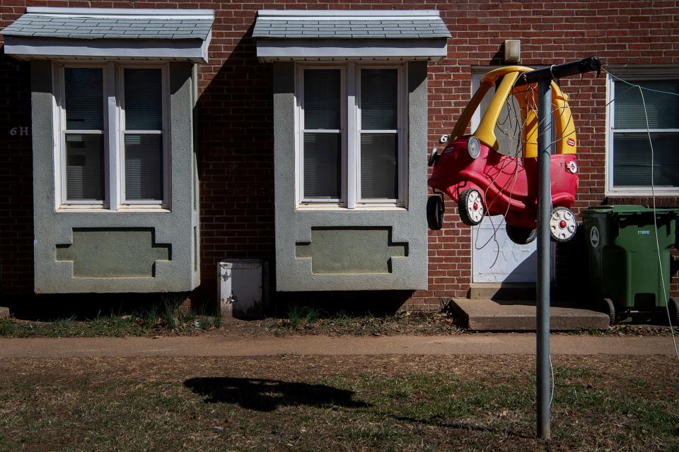 A Little Tikes car hangs on a clothes line at Pisgah View Apartments, February 15, 2024.