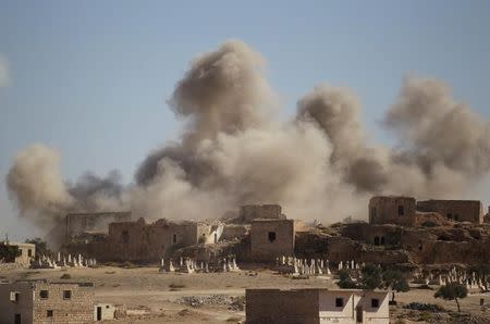 Smoke rises behind the ancient castle of the rebel-controlled town of Maaret al-Numan after airstrikes in Idlib province, Syria, September 25, 2016. REUTERS/Khalil Ashawi