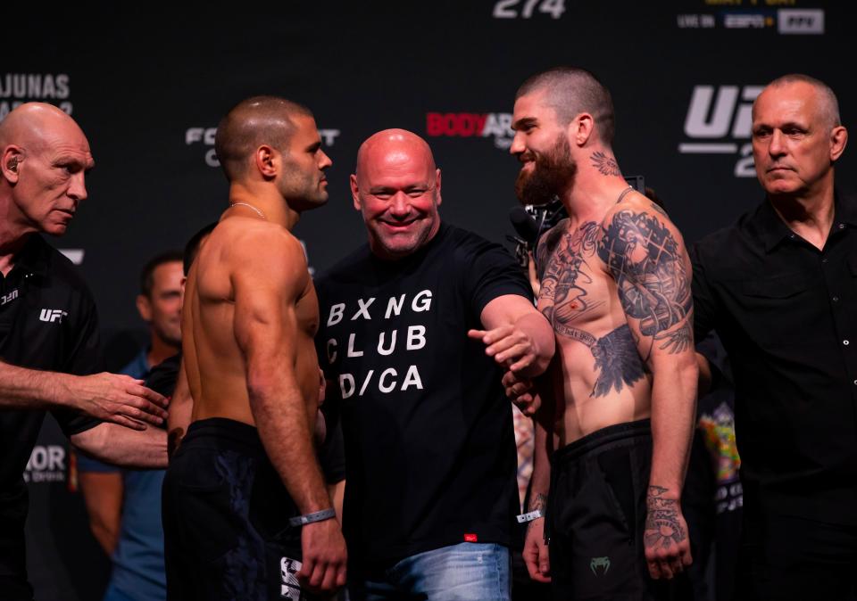 UFC fighter Andre Fialho, left, is separated from Cameron VanCamp by UFC president Dana White during weigh-ins for UFC 274 at the Arizona Federal Theatre on May 6.