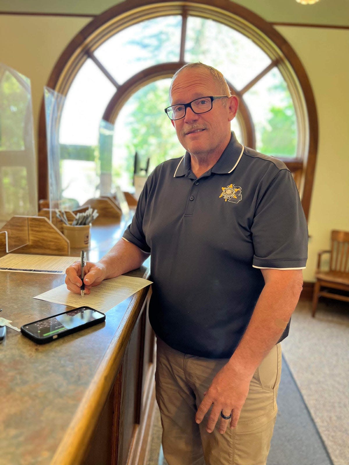 St. Joseph County Undersheriff Jason Bingaman completes paperwork Thursday at the county clerk’s office, making his candidacy for sheriff official.