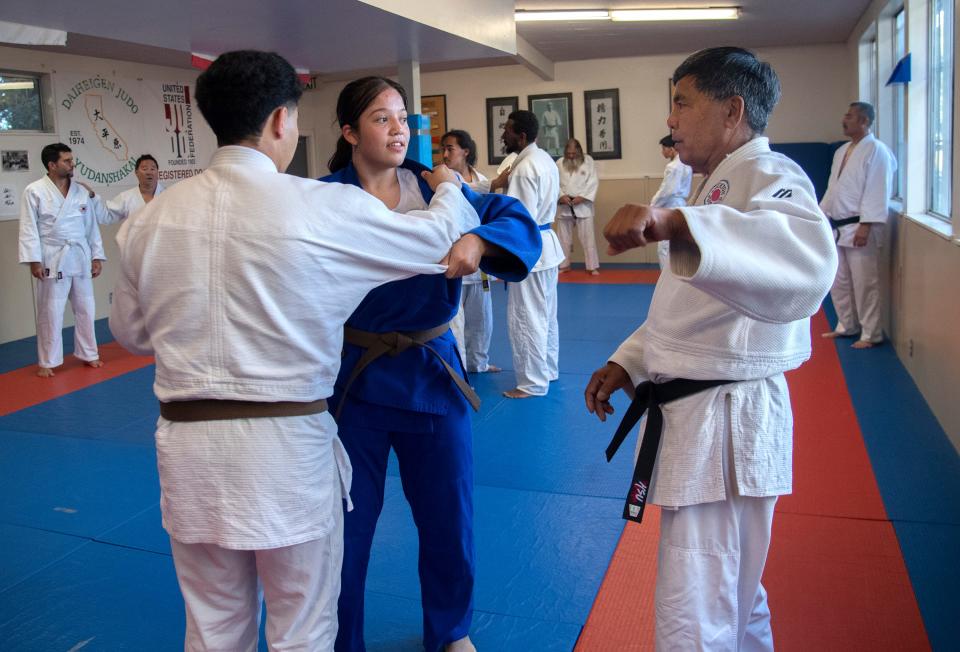 Instructor Dean Komure gives tips to students Joseph Hernandez and Alejandra Ochoa during a practice of the Stockton Judo Club at the McKinley Park Community Center in south Stockton.