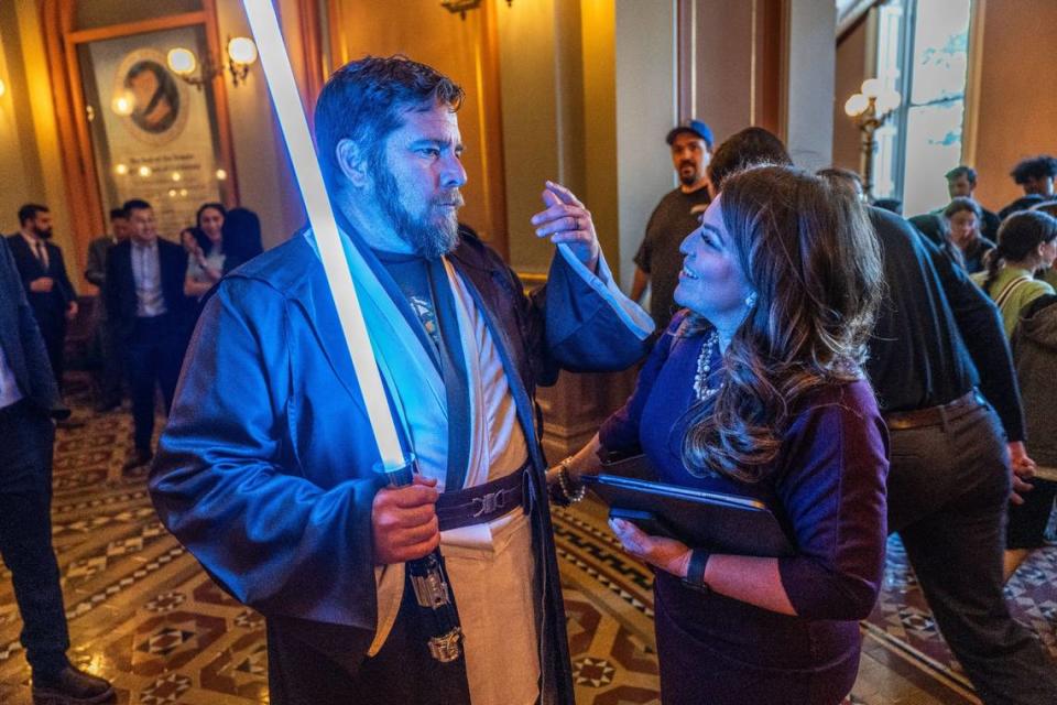 Assemblyman Juan Alanis, R-Modesto, wearing Jedi robes and carrying a lightsaber to celebrate Star Wars and Modesto native George Lucas, speaks with Assemblywoman Esmeralda Soria, D-Merced, at the state Capitol on Thursday. “It’s a big day in my district,” he said. “Saturday will actually be May the 4th and I’ll actually be dressed this way in the Centre Plaza in Modesto.”
