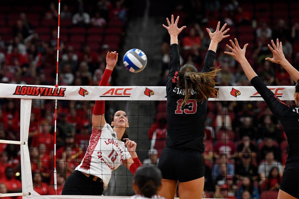 Louisville's Cara Cresse (13) attempts to score over the Stanford defense during the third game of the Cardinals' match against Stanford, Sunday, Sept. 17, 2023, in Louisville Ky. Louisville lost to Stanford 3-2.