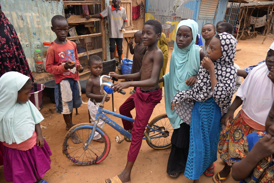 Children play in the streets in Niamey, Niger, Wednesday, Aug. 16, 2023. Nigeriens are preparing for a possible invasion by countries in the region, three weeks after mutinous soldiers ousted the nation’s democratically elected president. (AP Photo/Sam Mednick)